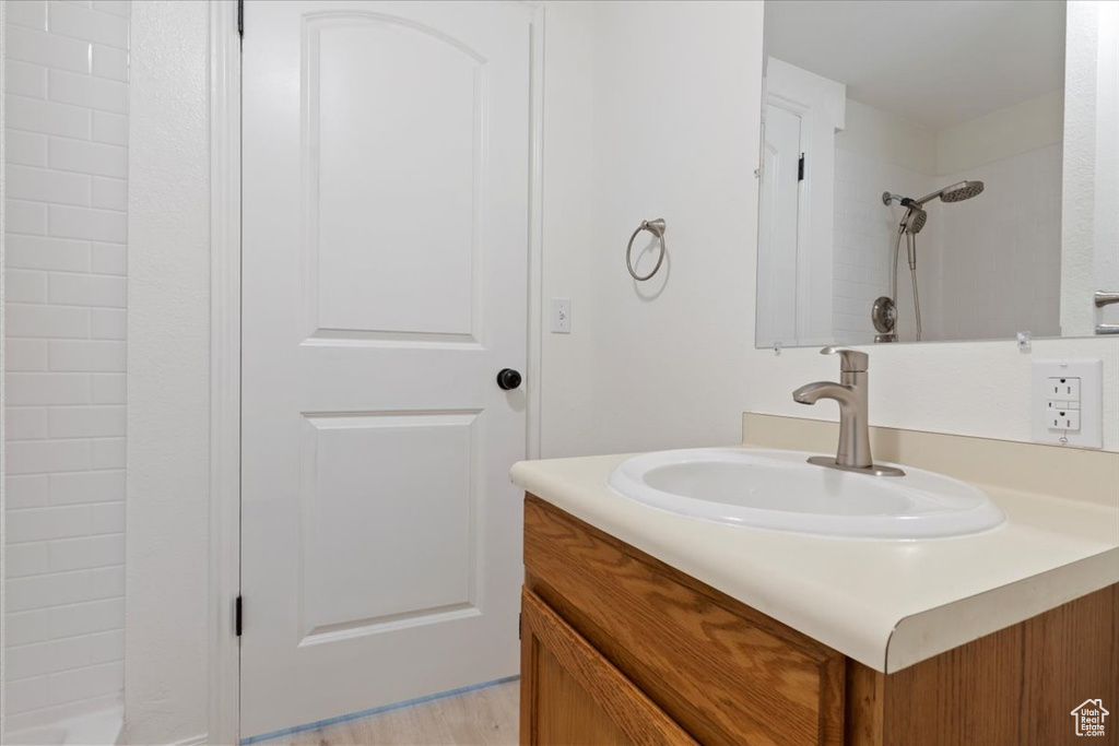Full bath with vanity and a shower