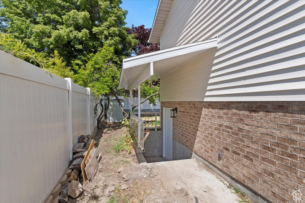 View of home\\\\\\\'s exterior featuring fence and brick siding
