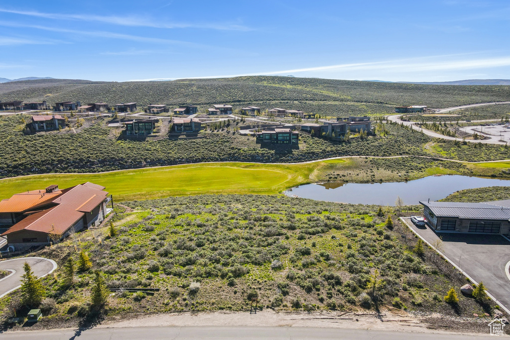 Aerial perspective of suburban area featuring a water and mountain view and a golf course