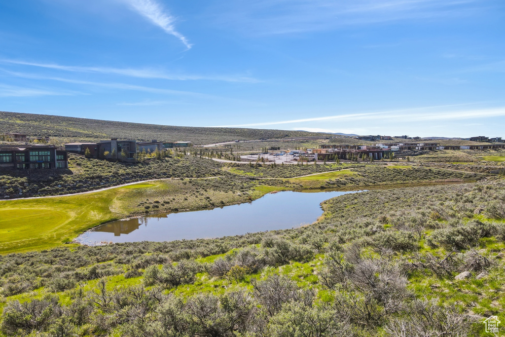 Drone / aerial view of a water and mountain view and a golf course