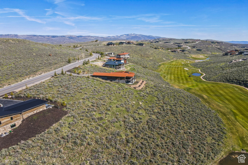 Aerial view of property's location featuring mountains and a golf course