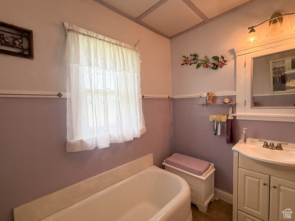 Bathroom featuring a bath and vanity