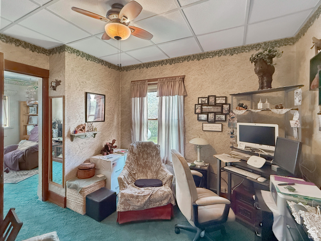 Carpeted office space featuring ceiling fan