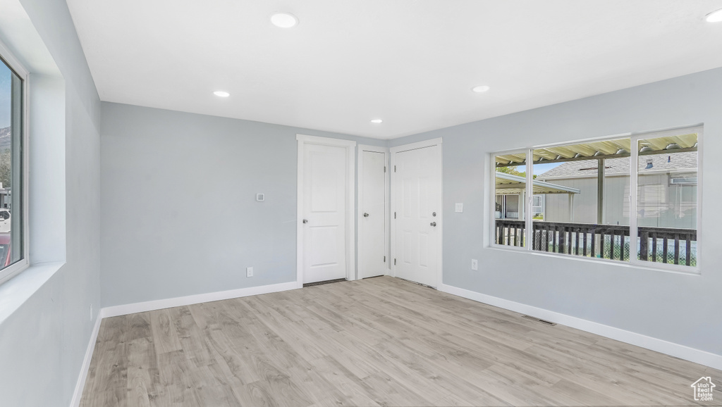 Spare room featuring wood finished floors, baseboards, and recessed lighting