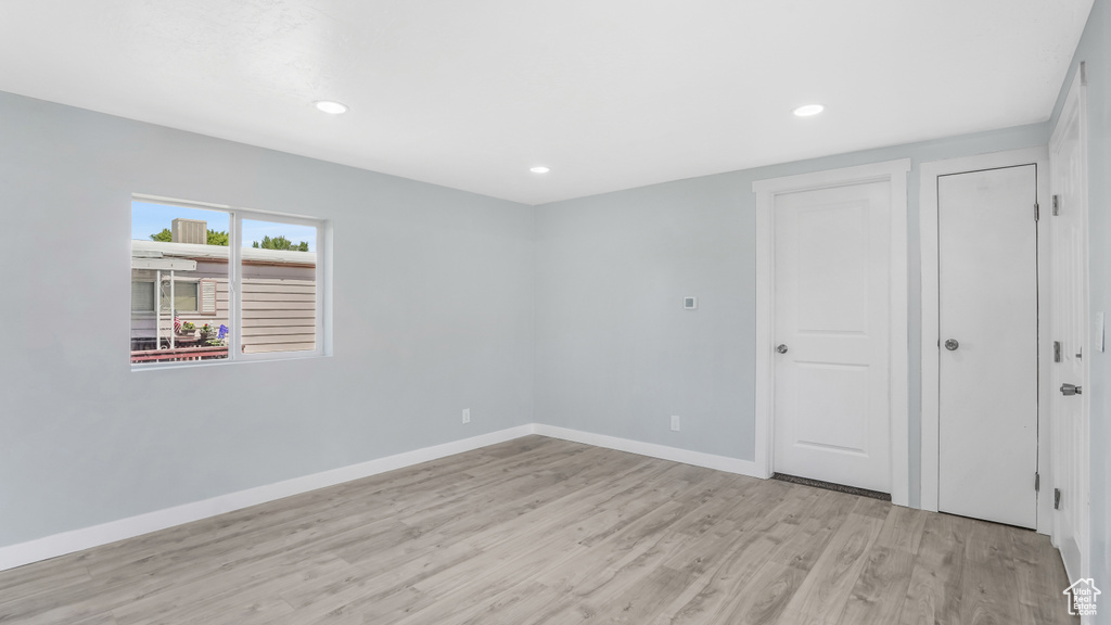 Unfurnished bedroom featuring light wood-type flooring, baseboards, and recessed lighting