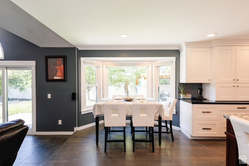 Dining room featuring dark wood finished floors, recessed lighting, and baseboards