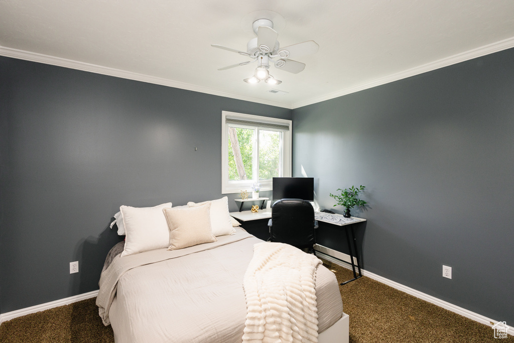 Carpeted bedroom with baseboards, ornamental molding, ceiling fan, and an office area