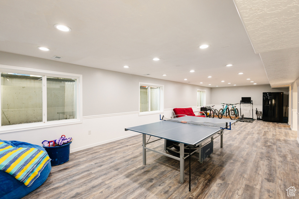 Recreation room featuring wood finished floors and recessed lighting