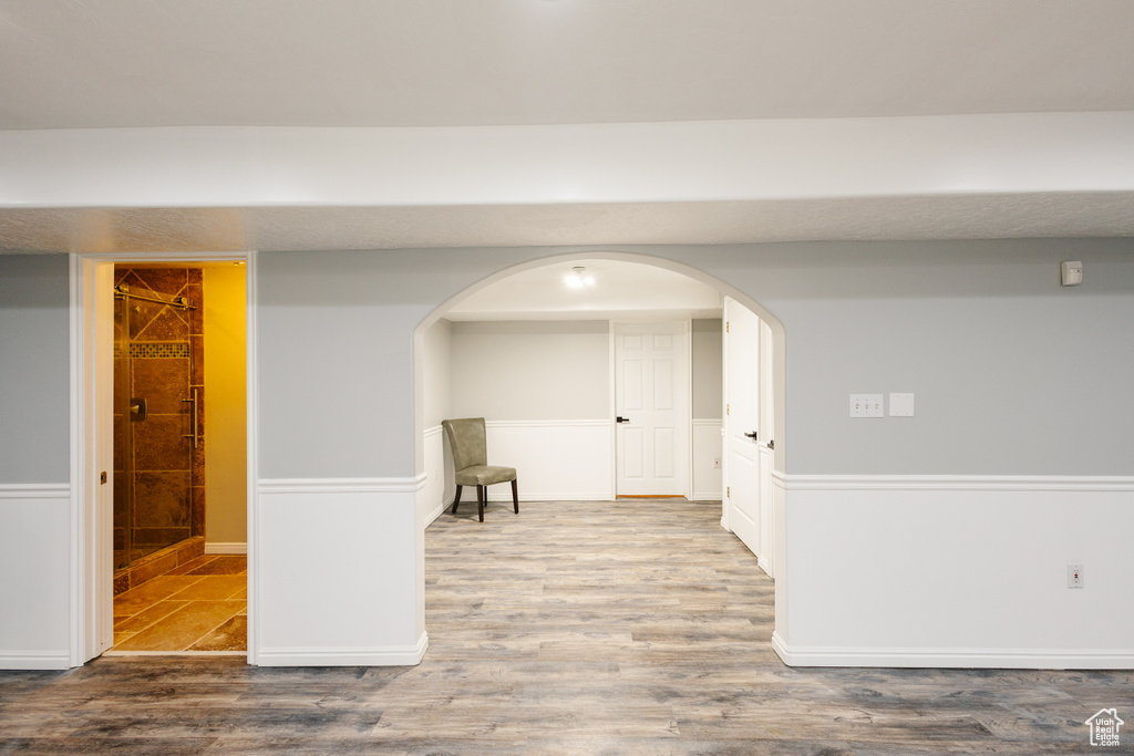 Below grade area with wood finished floors and arched walkways