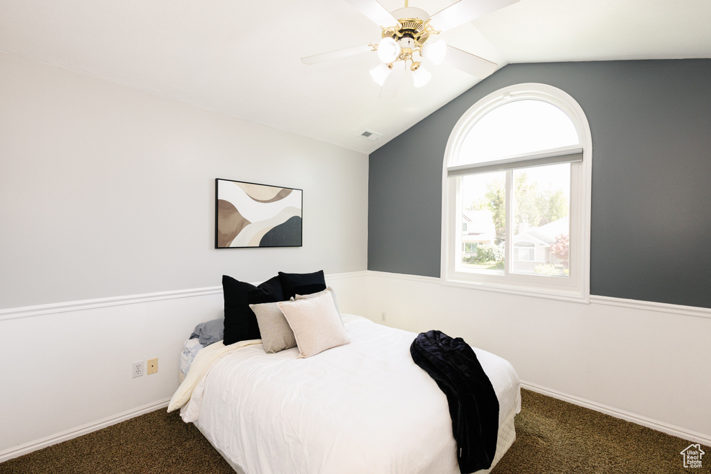 Bedroom featuring carpet floors, lofted ceiling, baseboards, and a ceiling fan