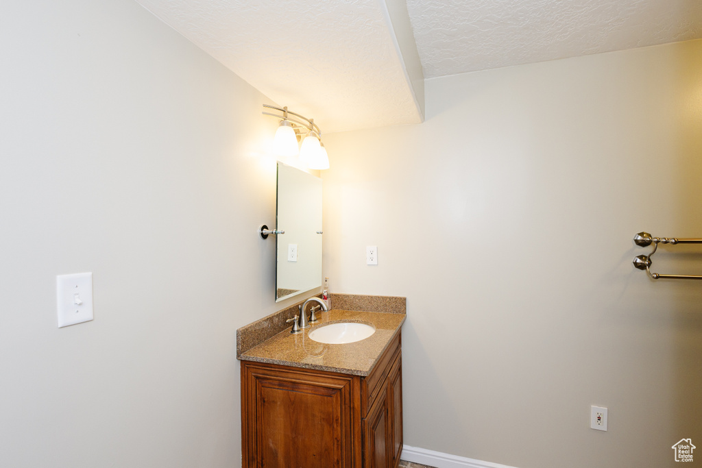 Bathroom with vanity and a textured ceiling