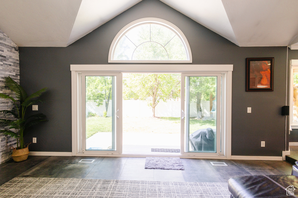 Entryway featuring lofted ceiling, healthy amount of natural light, and baseboards
