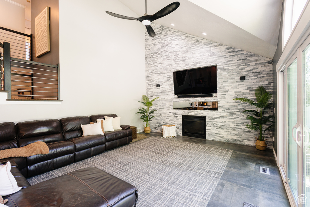 Living area with high vaulted ceiling, a fireplace, a ceiling fan, wood finished floors, and recessed lighting