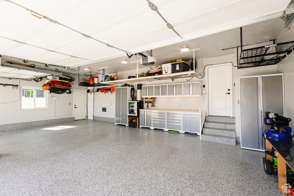 Garage with a garage door opener and baseboards