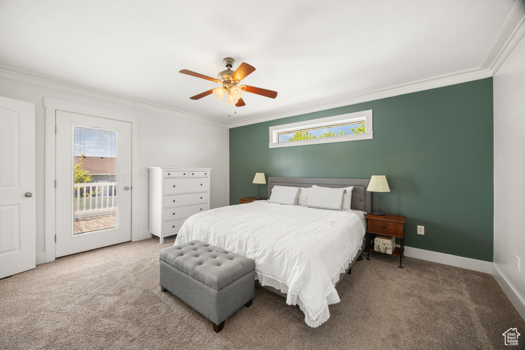 Carpeted bedroom with crown molding, access to exterior, a ceiling fan, and baseboards