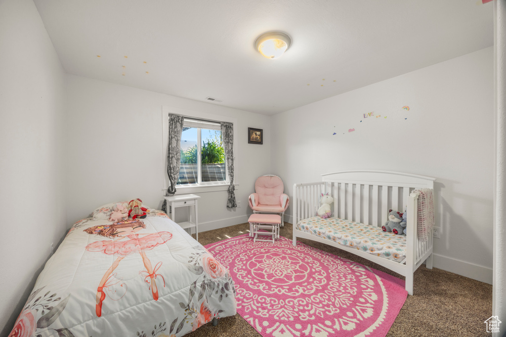 Carpeted bedroom featuring baseboards