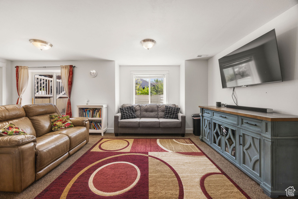 Carpeted living area with baseboards