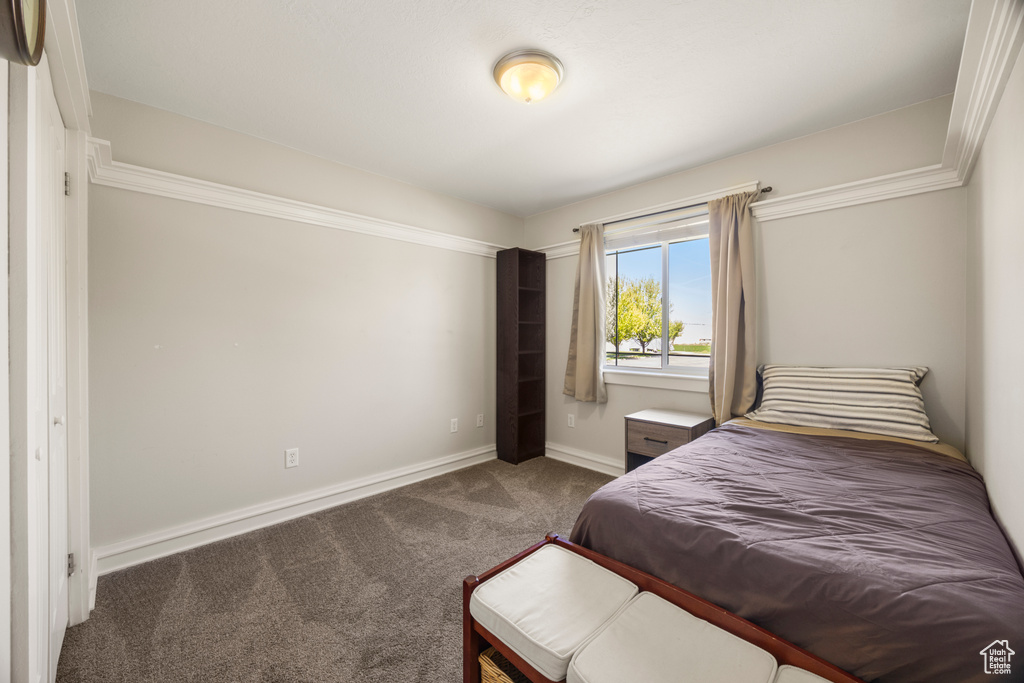 Bedroom with carpet flooring and baseboards