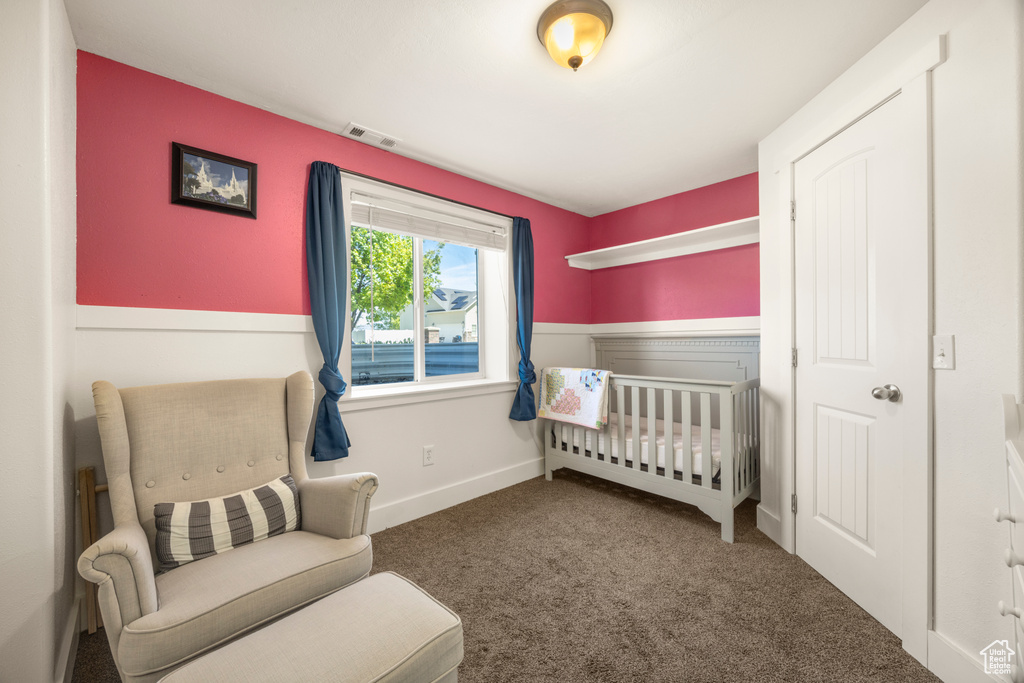 Bedroom featuring carpet and baseboards