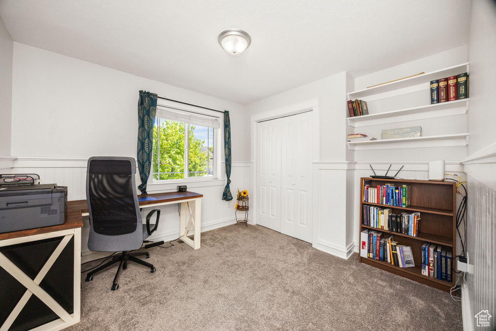 Office space featuring carpet floors and wainscoting