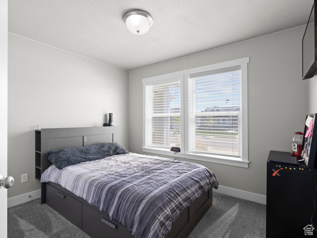 Carpeted bedroom with baseboards