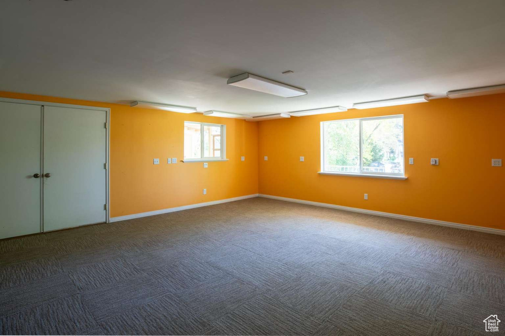 Spare room with plenty of natural light, carpet floors, and baseboards