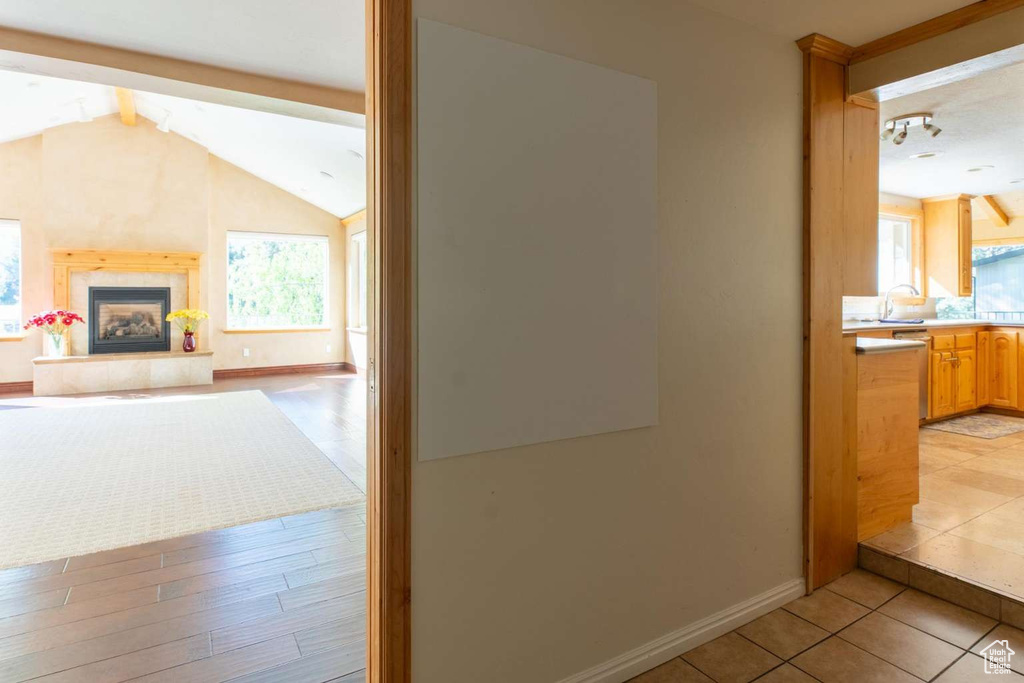 Corridor with plenty of natural light, baseboards, and light tile patterned floors