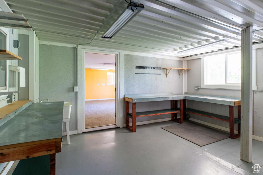 Basement featuring a workshop area and baseboards