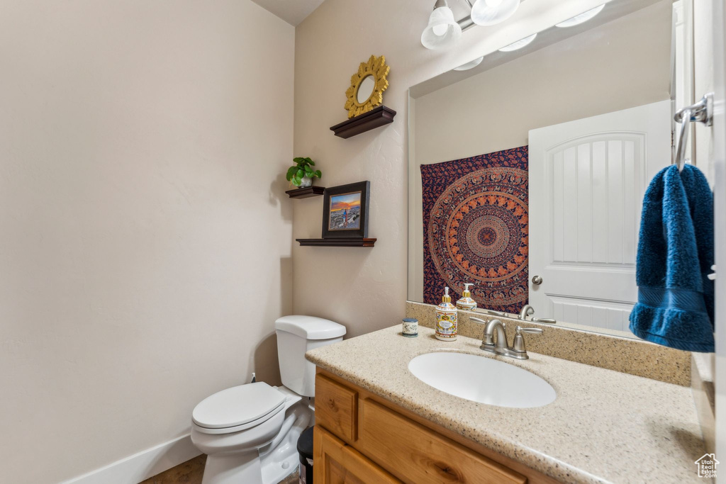 Half bathroom featuring toilet and vanity