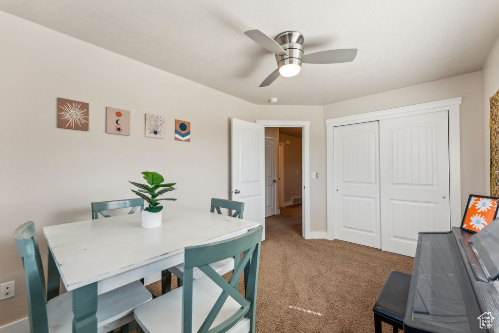 Dining area with carpet, a ceiling fan, an office area, and baseboards