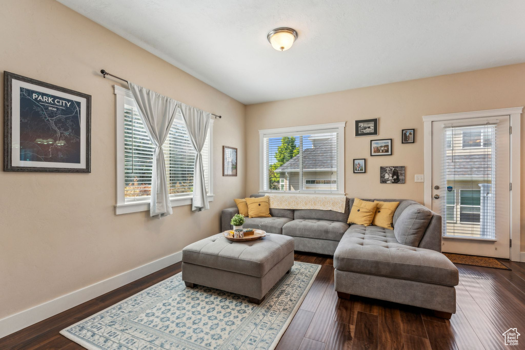 Living area with dark wood finished floors and baseboards