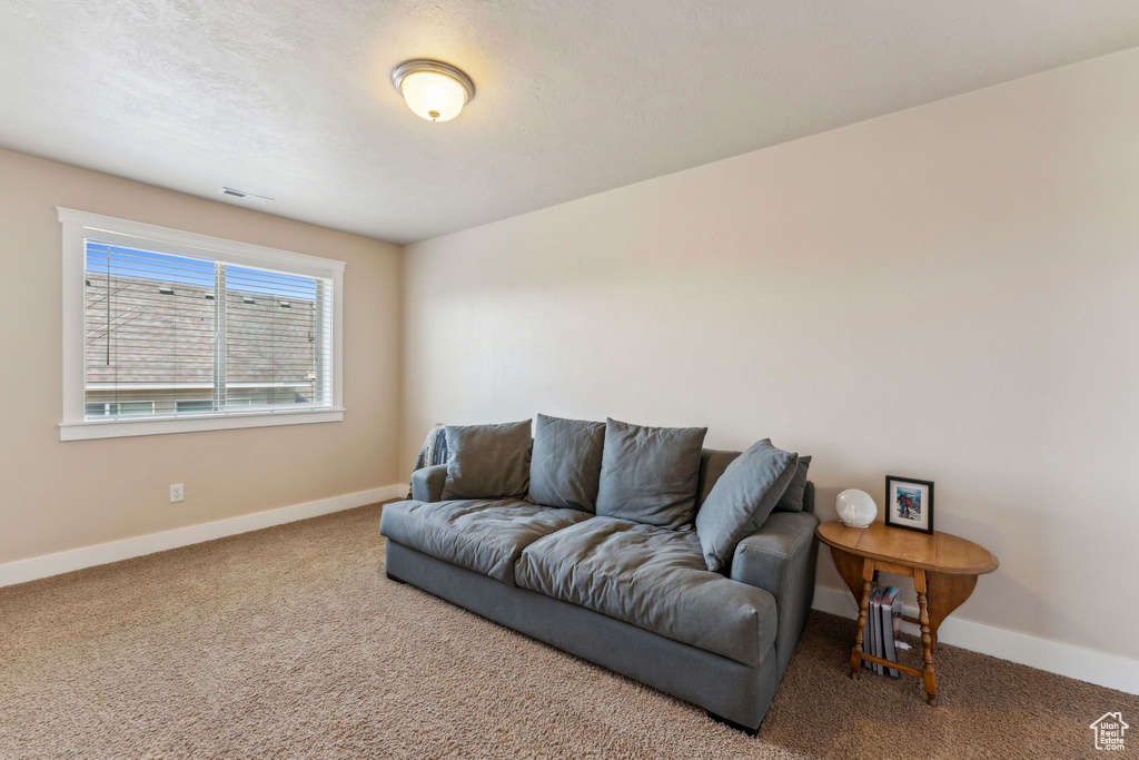 Living area with carpet flooring and baseboards