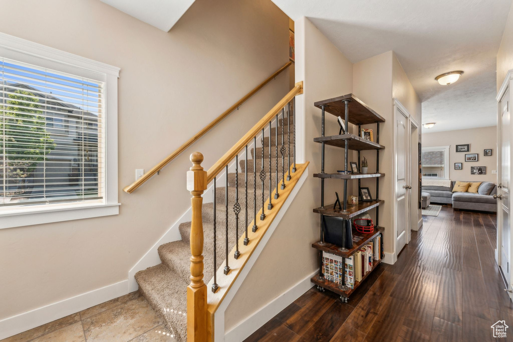 Stairway featuring baseboards and wood finished floors