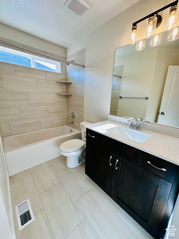 Full bath with toilet, vanity, bathing tub / shower combination, and a textured ceiling