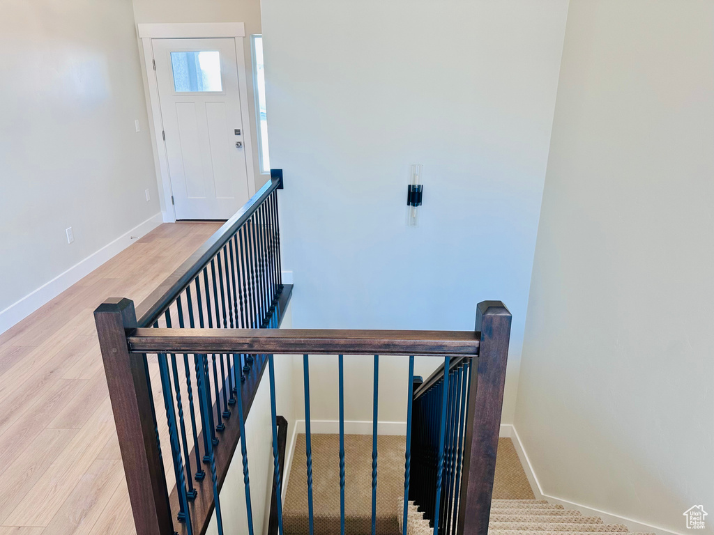 Staircase featuring baseboards and wood finished floors