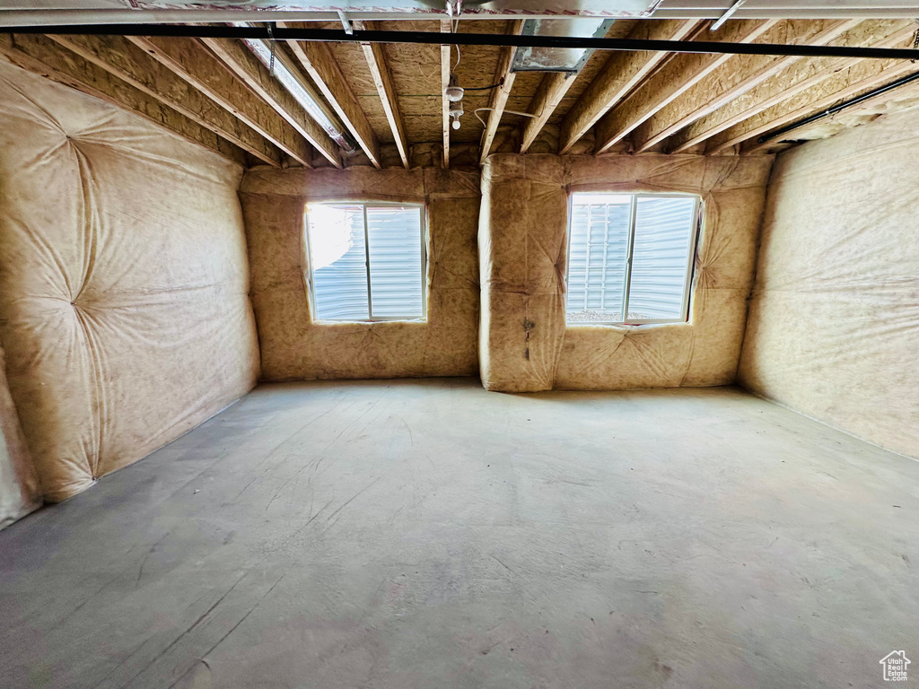 Miscellaneous room featuring healthy amount of natural light and concrete floors