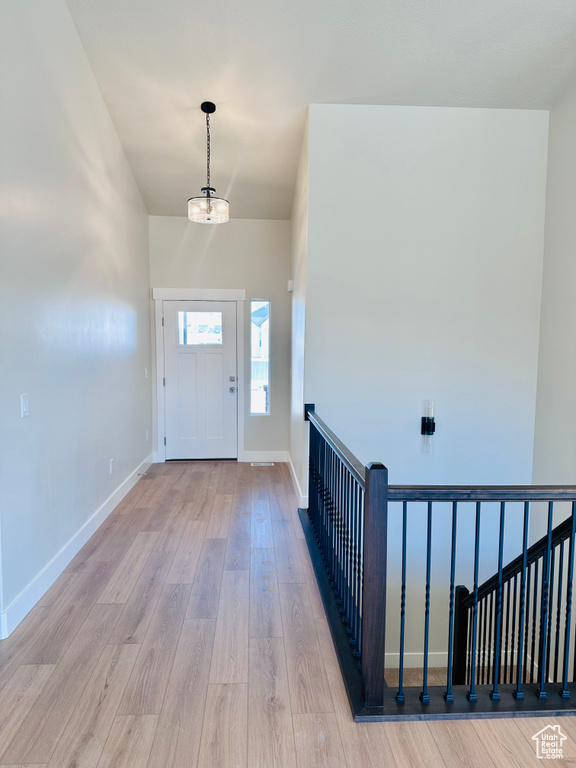 Entryway with wood finished floors and baseboards