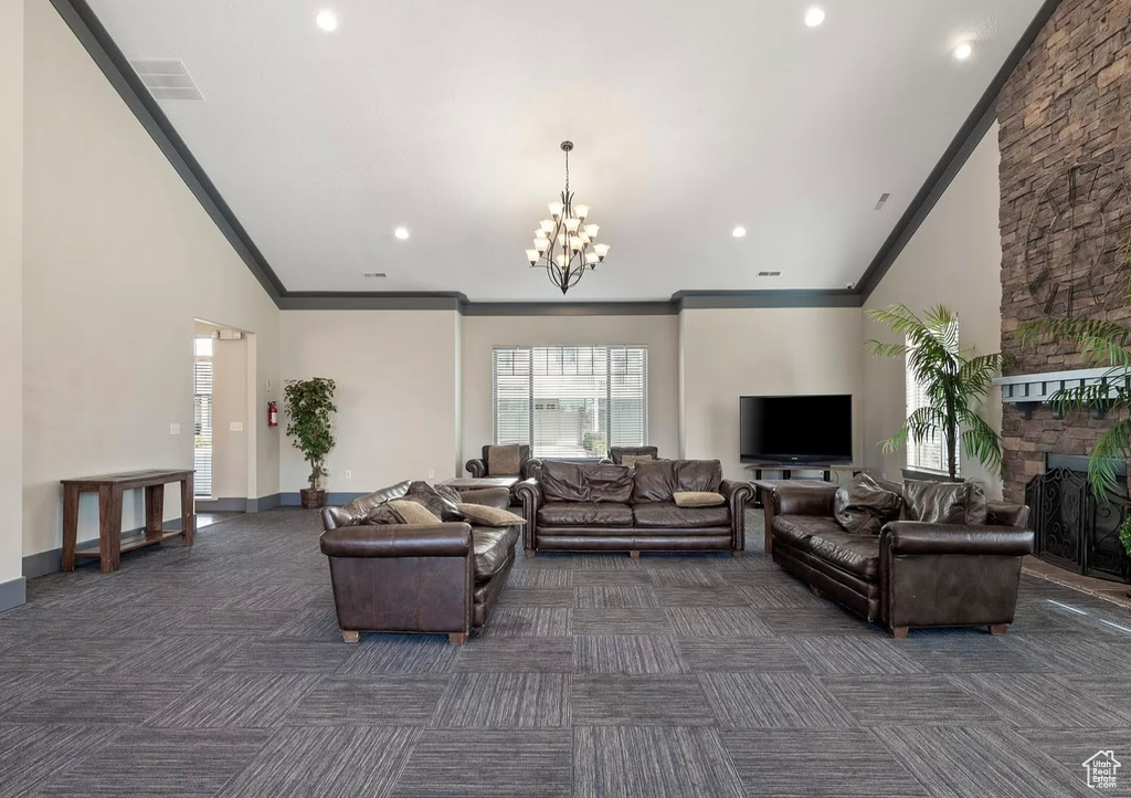 Living room featuring dark colored carpet, crown molding, a chandelier, recessed lighting, and baseboards