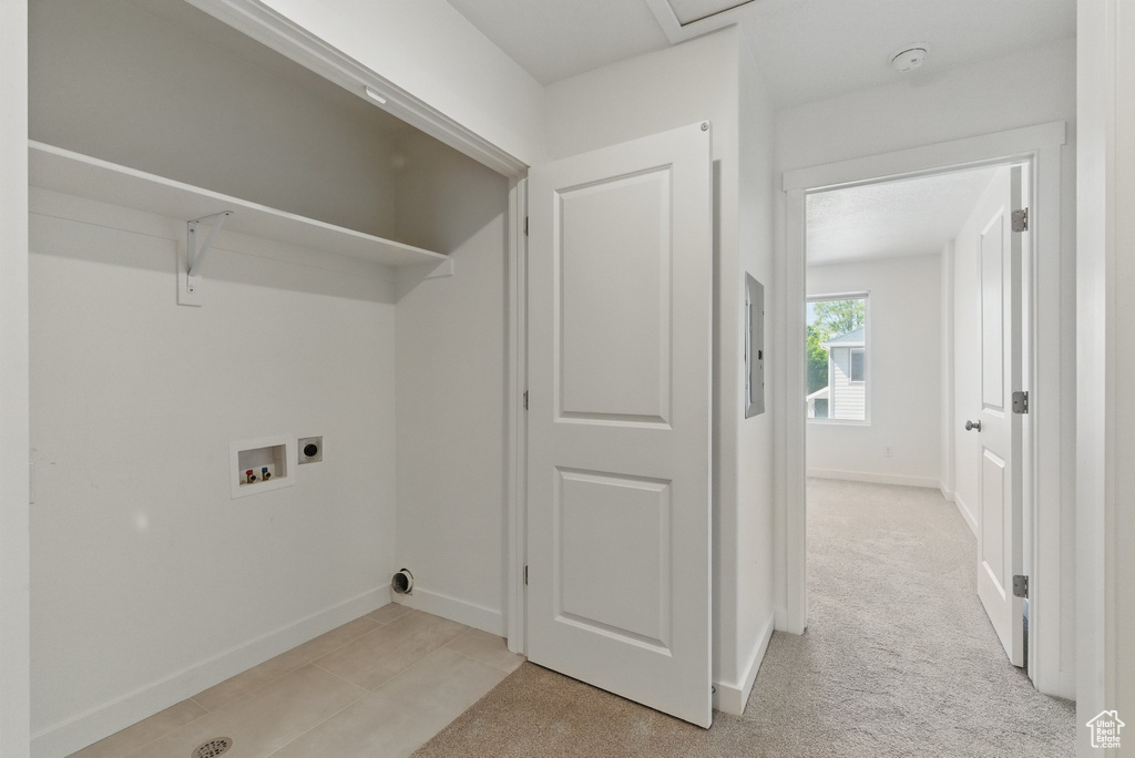 Washroom with electric dryer hookup, washer hookup, and baseboards