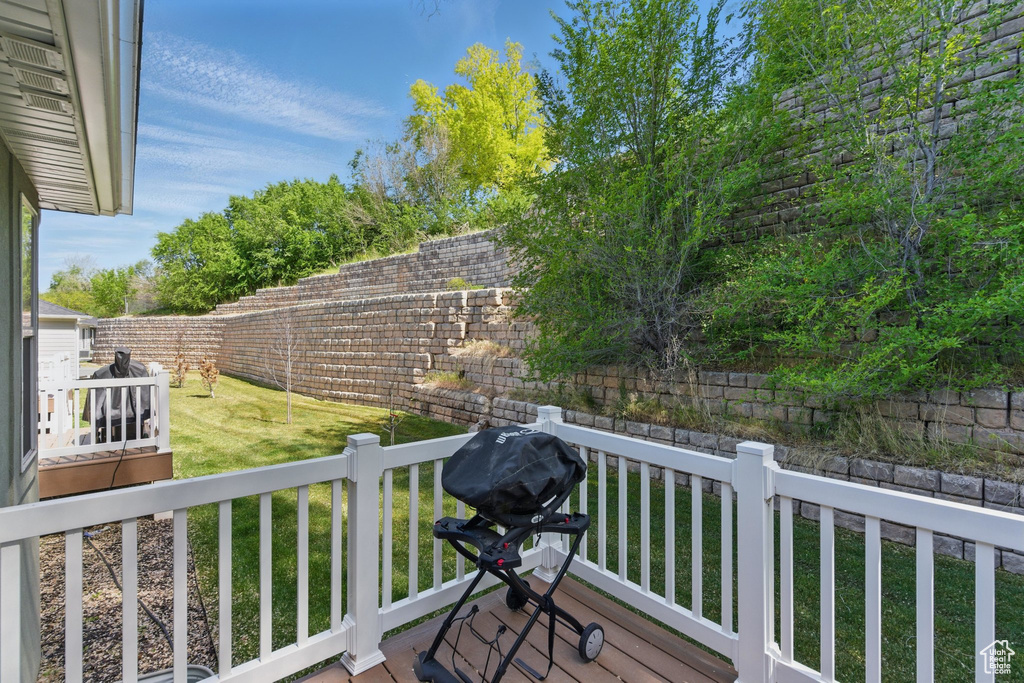 Wooden terrace featuring grilling area