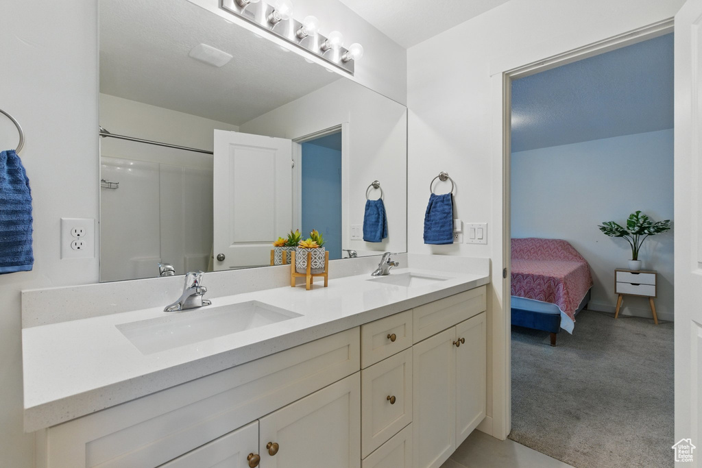 Full bathroom with double vanity and ensuite bathroom