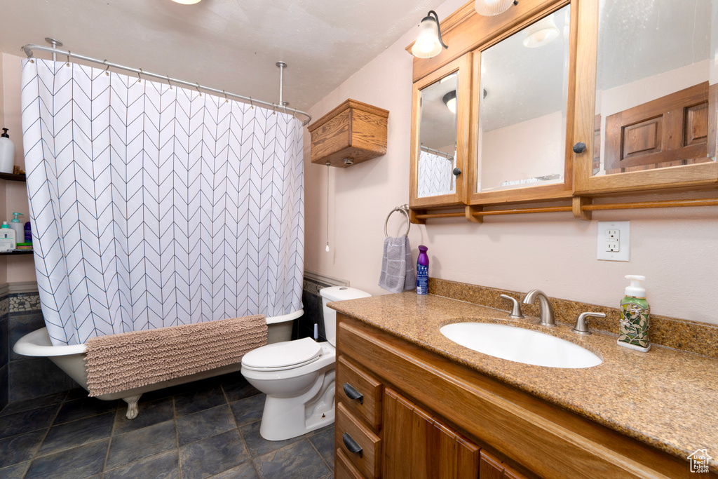 Full bath featuring toilet, vanity, and shower / bath combination with curtain