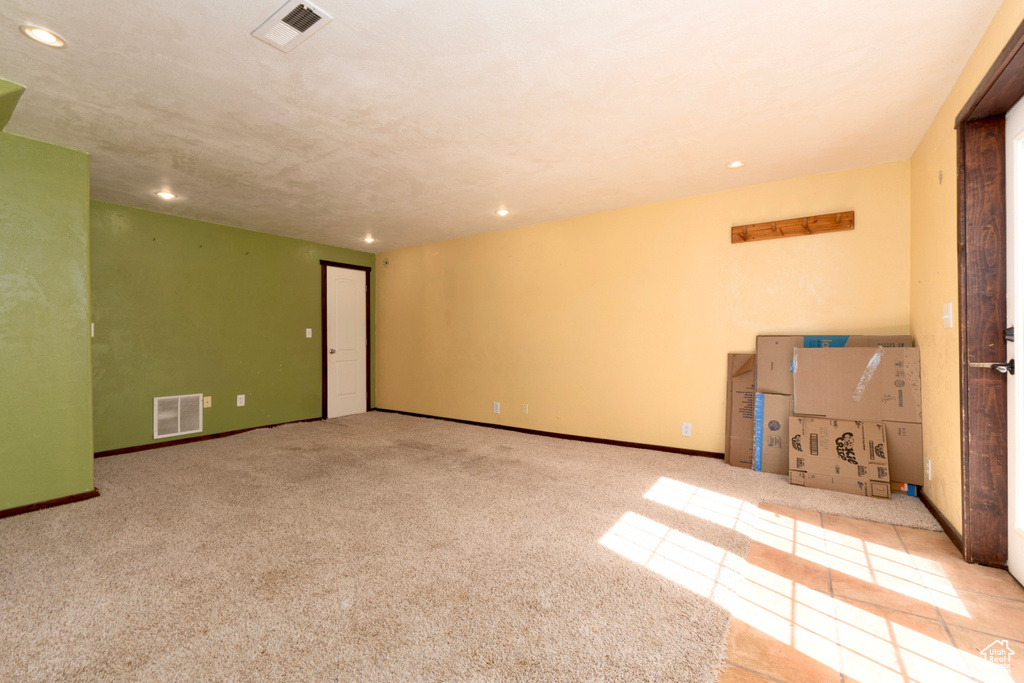 Carpeted empty room with recessed lighting and baseboards