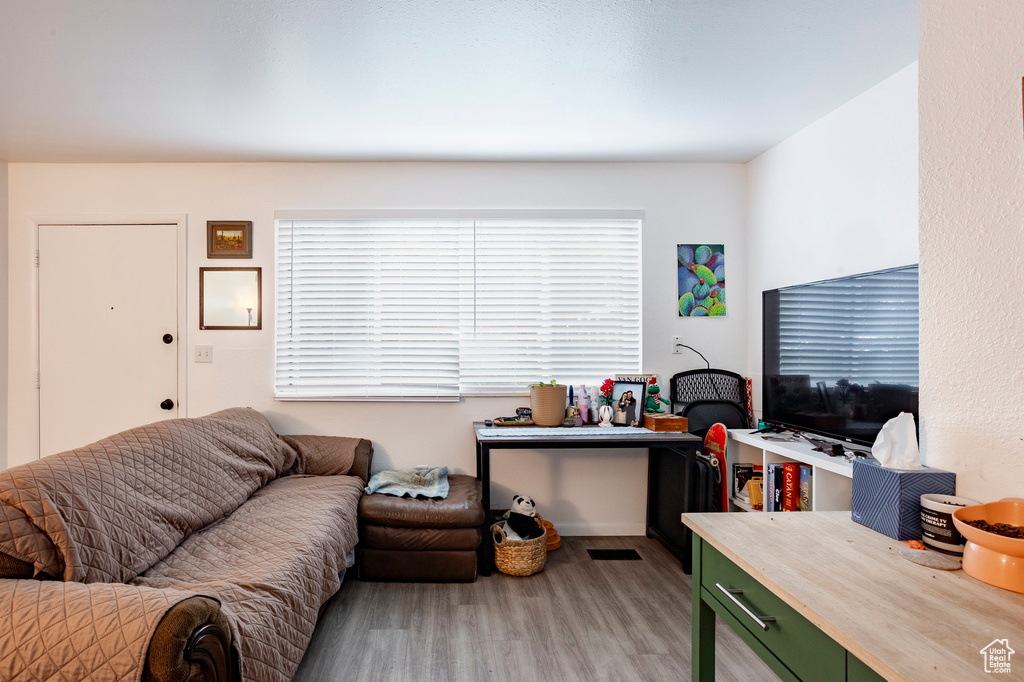 Living area with wood finished floors and plenty of natural light