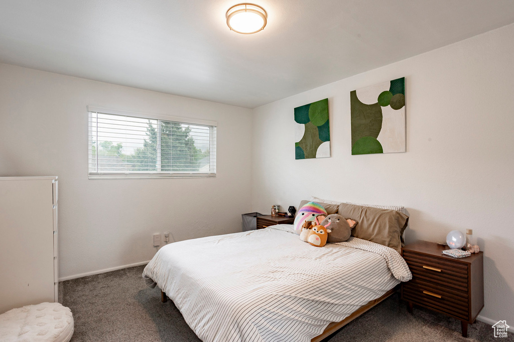 Bedroom featuring carpet flooring and baseboards
