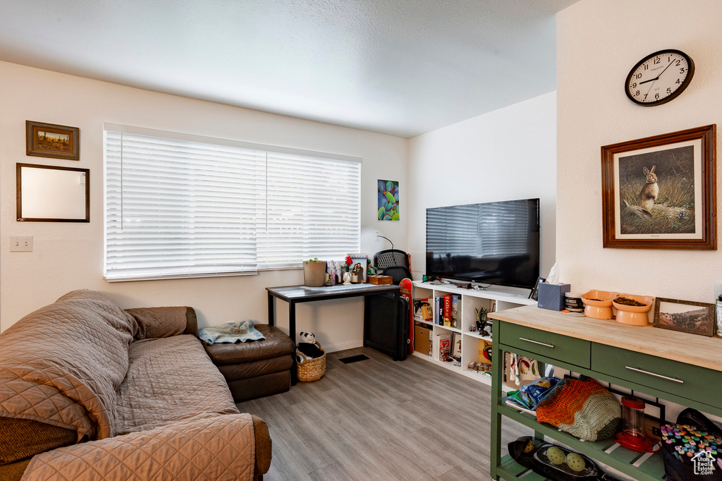 Living area featuring light wood-type flooring and baseboards