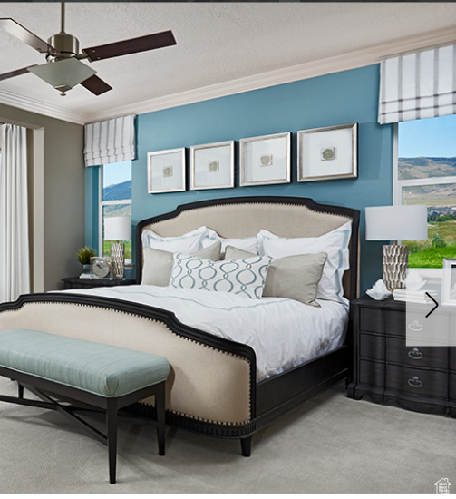 Carpeted bedroom with ornamental molding, a ceiling fan, and a textured ceiling