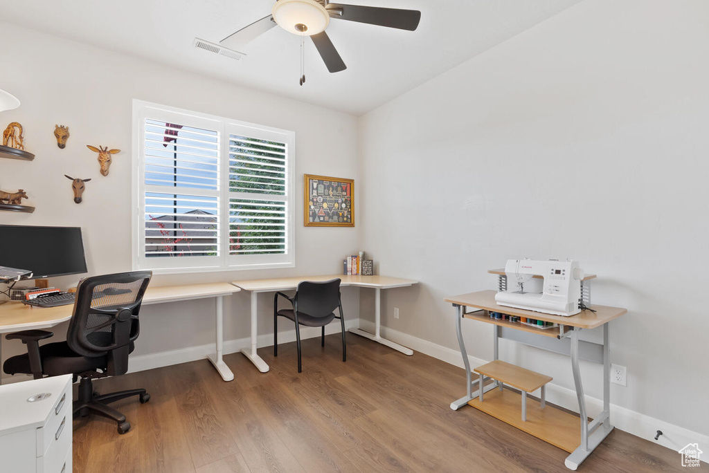 Office featuring wood finished floors, a ceiling fan, and baseboards