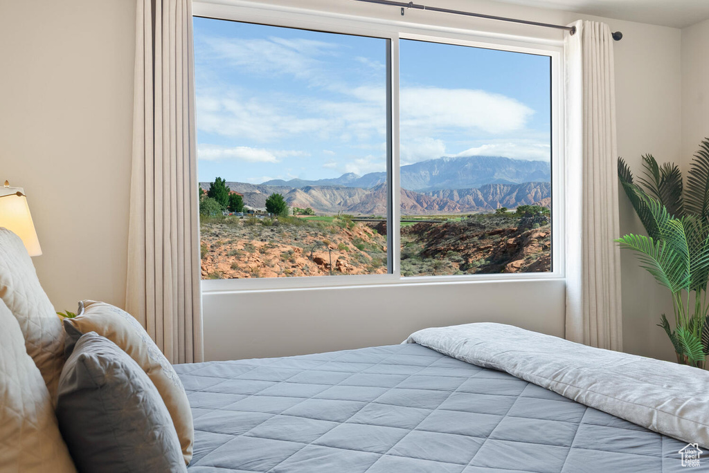 Bedroom featuring multiple windows and a mountain view