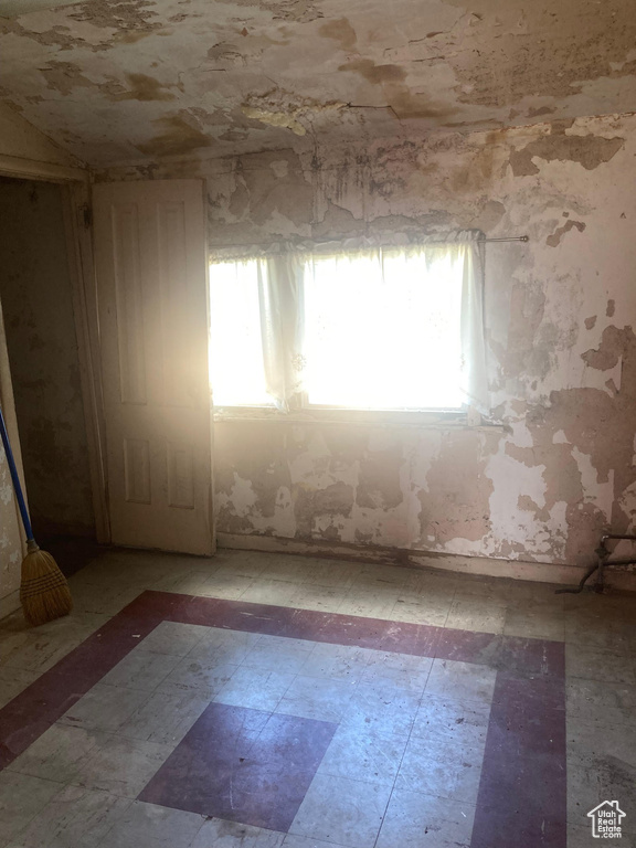 Unfurnished room with light flooring